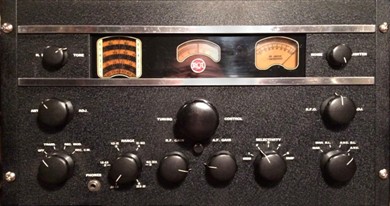 Rack-mounted radio receiver with 2 chrome trim strips, 2 dial windows a S Meter, a main tuning knob, and10 small knobs